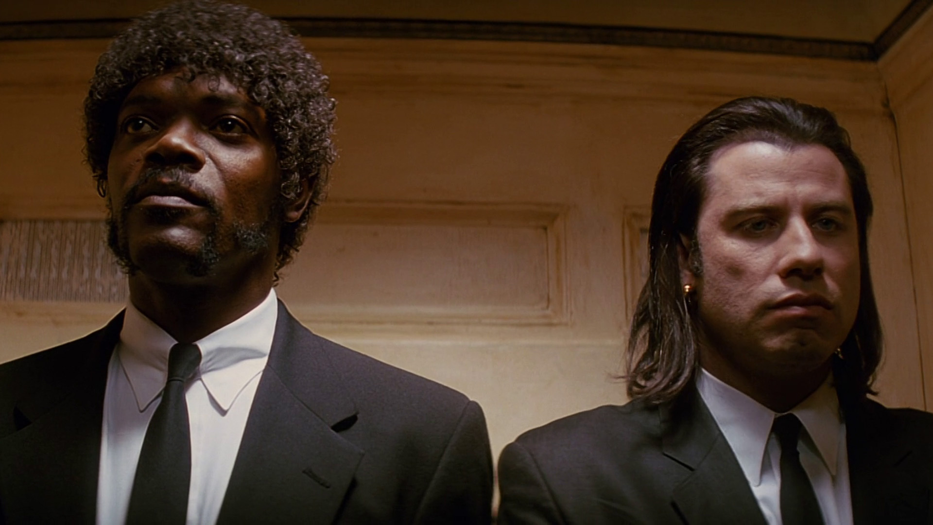 Samuel L Jackson and John Travolta wear black suits and ties in Pulp Fiction