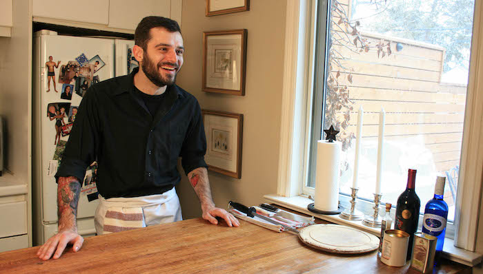 Chef Eric Wallis stands at the counter in his home kitchen.