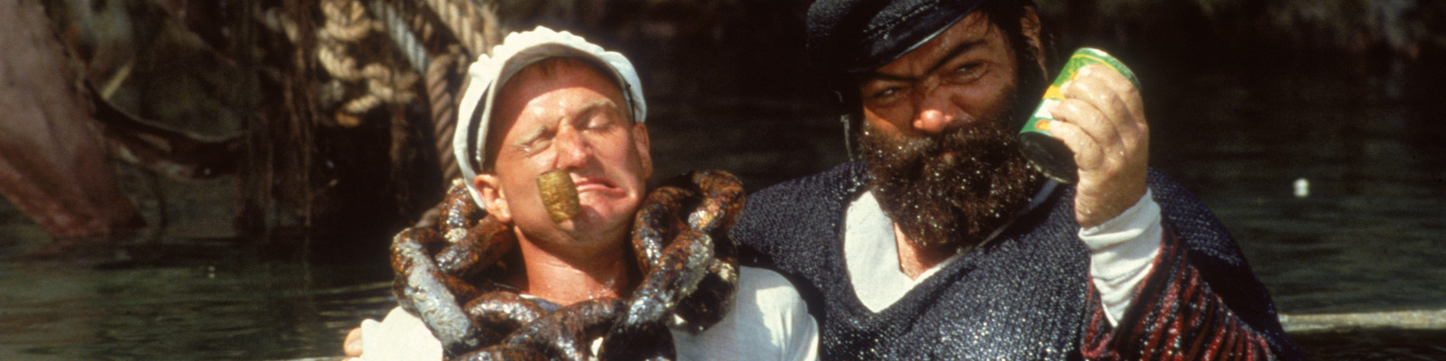 Paul L. Smith as Bluto catches Popeye (Robin Williams) in the water in Robert Altman's Popeye