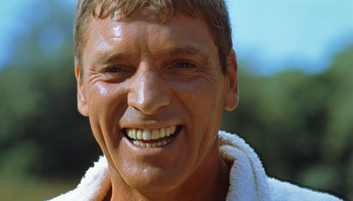 Burt Lancaster smiles in a close up in The Swimmer (1968)