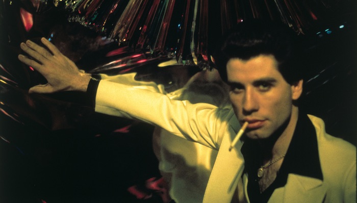 John Travolta in front of a mirrored wall in Saturday Night Fever