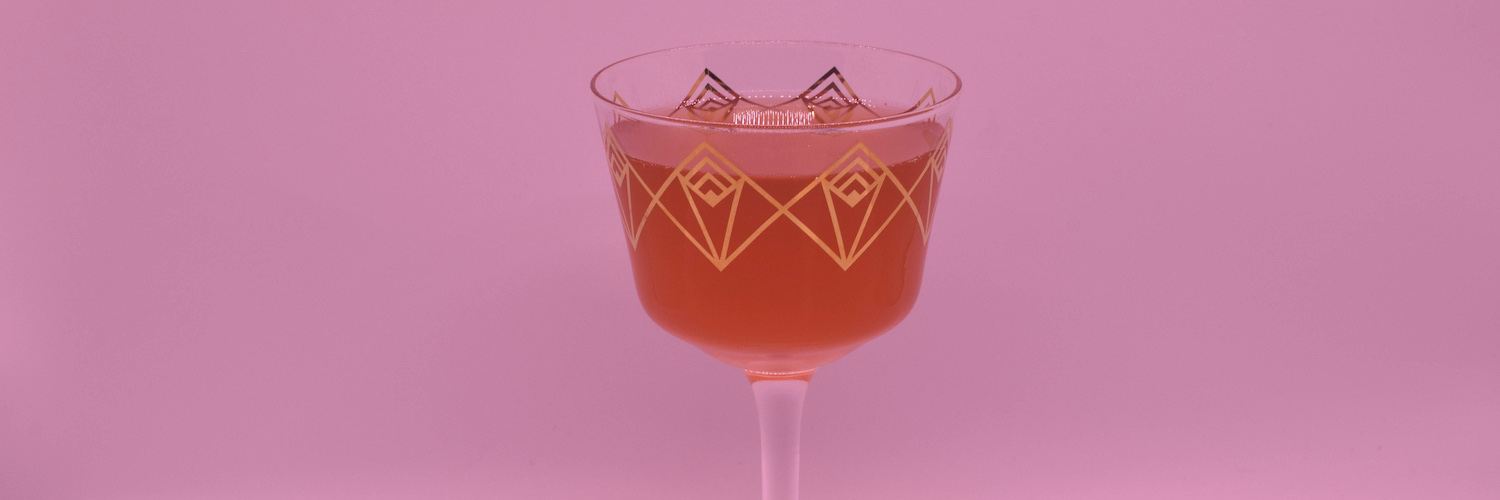 Satine Plum Sour – Moulin Rouge inspired cocktail in a tall, decorative coupe glass