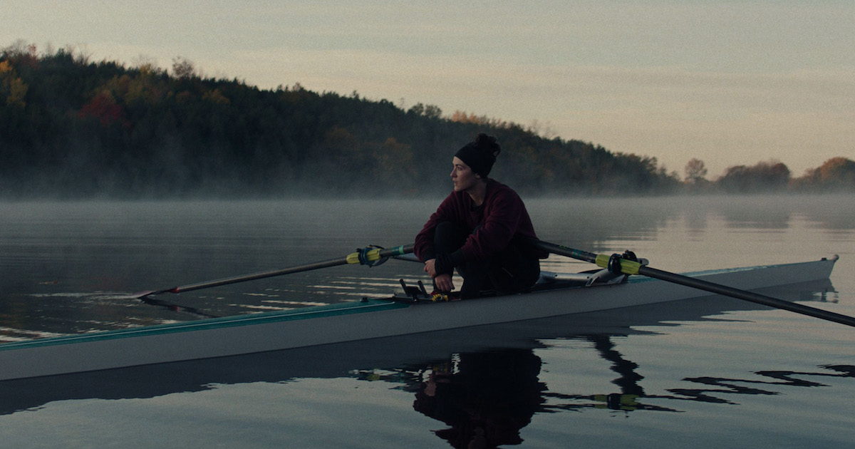 sabelle Fuhrman as ‘Alex Dall’ in Lauren Hadaway’s THE NOVICE sits in a rowing shell (boat) on a calm misty lake