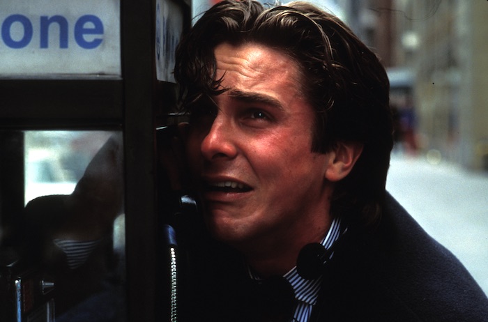 Christian Bale as Patrick Bateman cries into a payphone in American Psycho