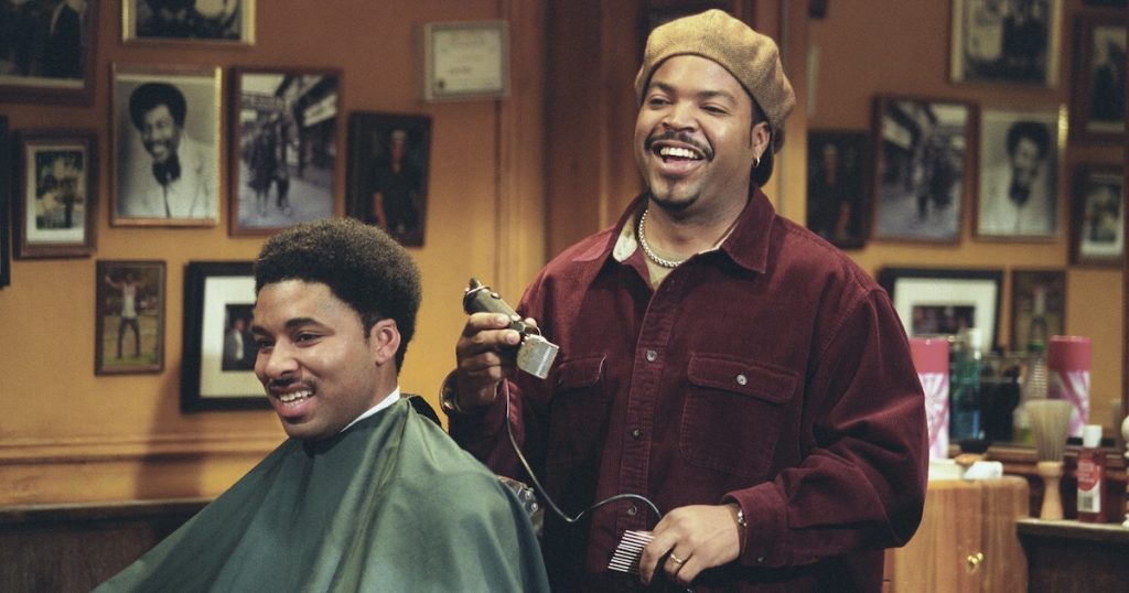 Ice Cube laughs as he takes a pause while cutting a customer's hair in Barbershop