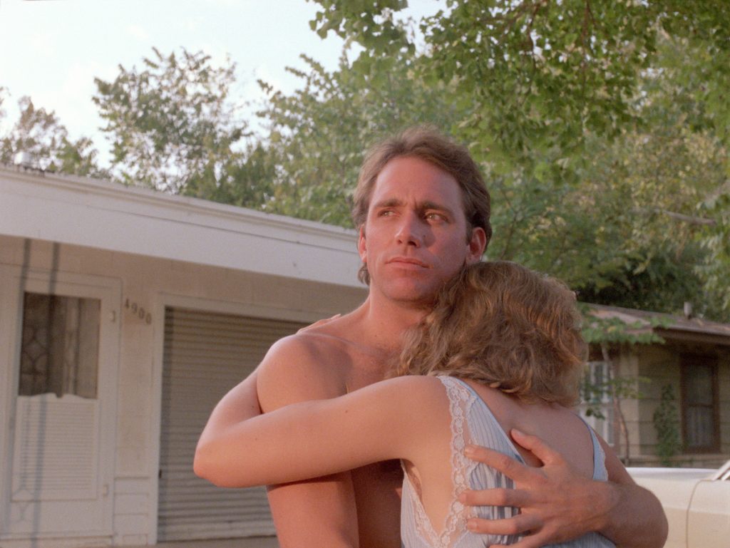 John Gets and Frances McDormand embrace outside a house