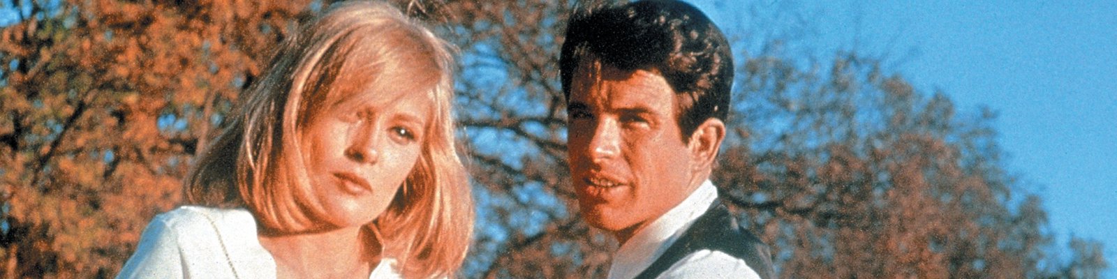 Faye Dunaway and Warren Beatty as Bonnie and Clyde pose outdoors in front of trees
