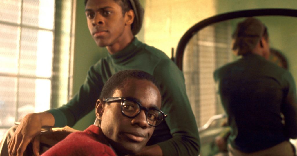 Lawrence Hilton-Jacobs and Glynn Turman in Cooley High sit on a dresser in a bedroom 
