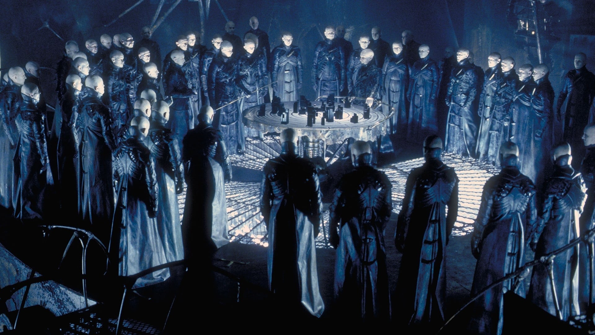 Alien "Strangers" gather around a circular table in Dark City