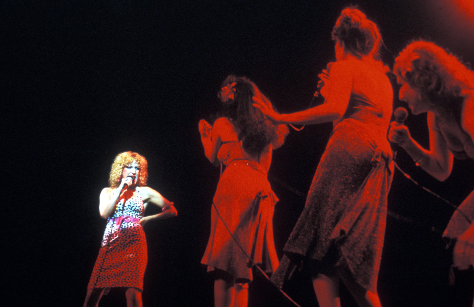 Bette Midler performs with her back up singers in the concert film Divine Madness