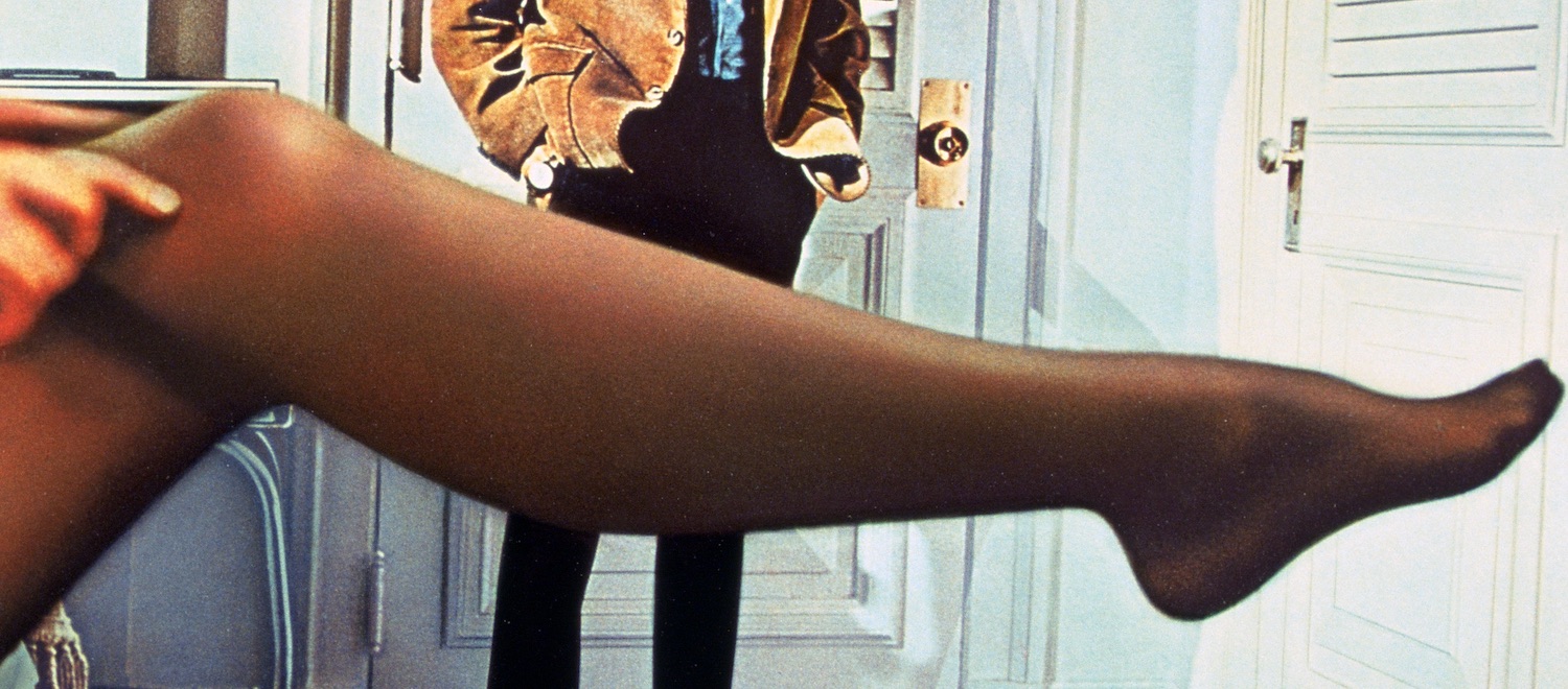 Benjamin Braddock (Dustin Hoffman) looks at Mrs. Robinson's outstretched leg (Anne Bancroft) in The Graduate