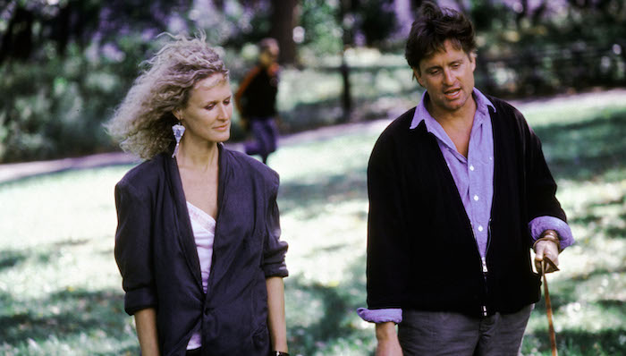 Glenn Close and Michael Douglas walk in a park in Fatal Attraction