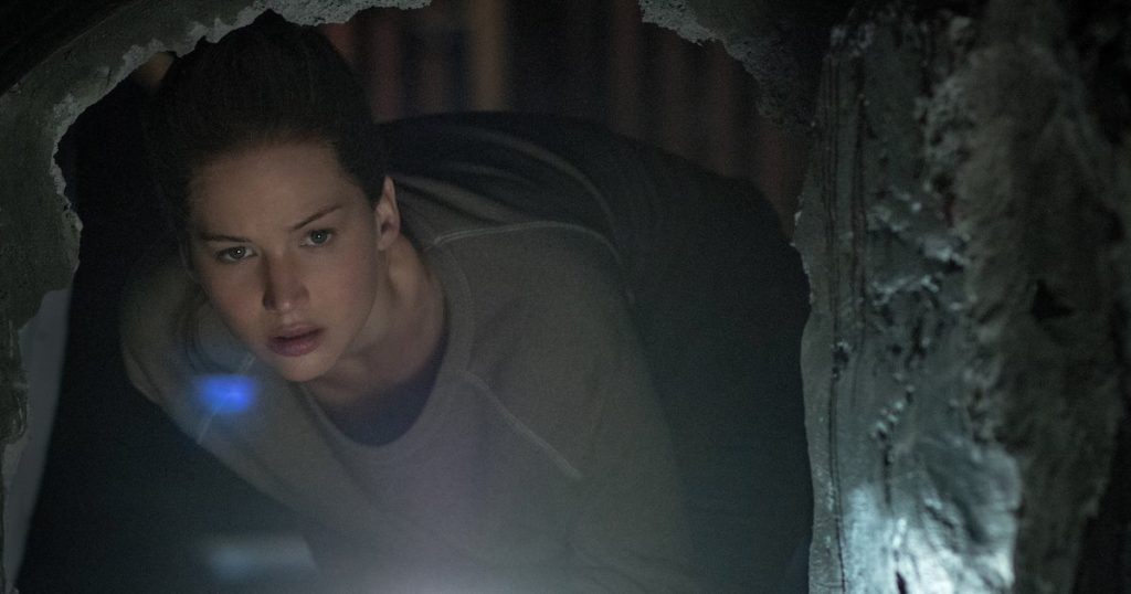 Jennifer Lawrence peers into a darkened hole in a wall