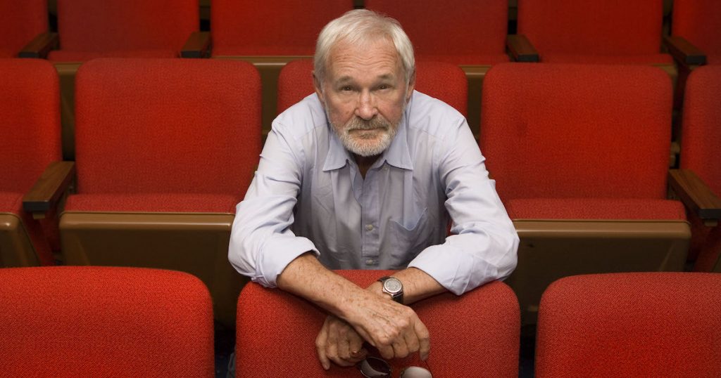 Norman Jewison sits in a movie theatre