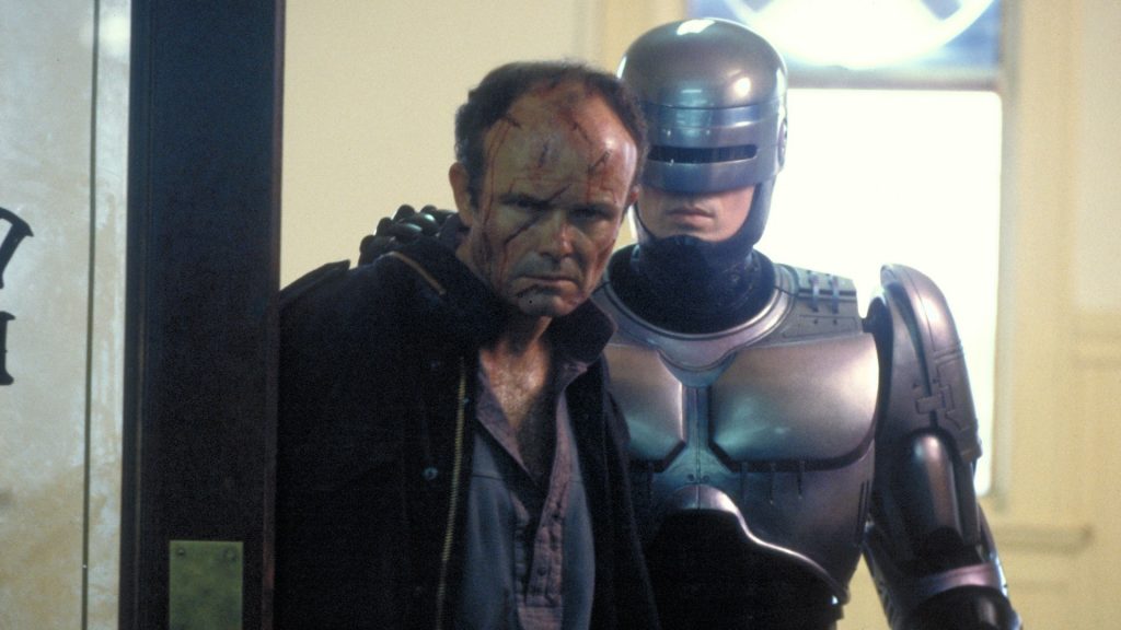 Peter Weller as Robocop arrests a criminal played by Kurtwood Smith in Robocop