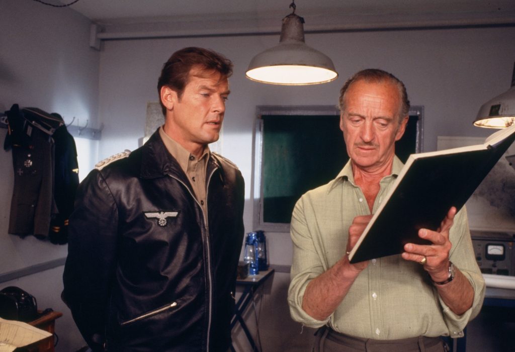 Roger Moore and David Niven consult a book in The Sea Wolves