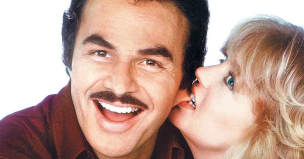 Goldie Hawn playfully bites a smiling Burt Reynold's ear – Poster art from Best Friends